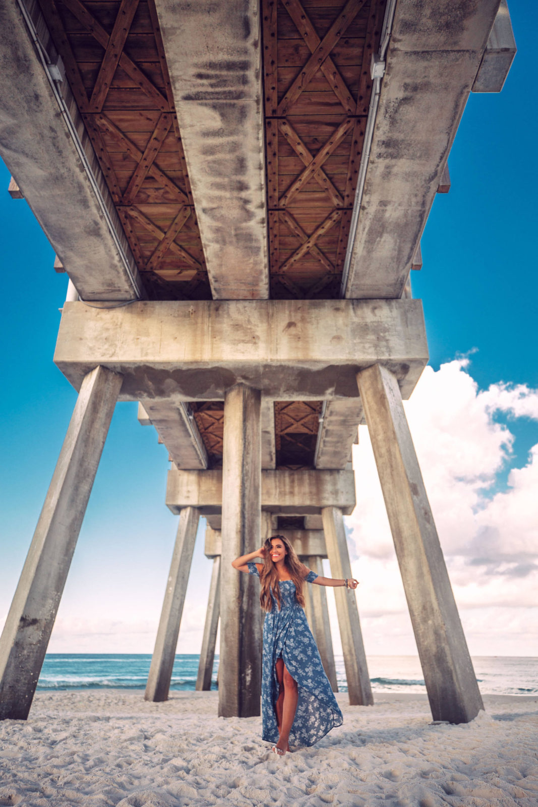 under the pier at panama city beach florida in a maxi dress